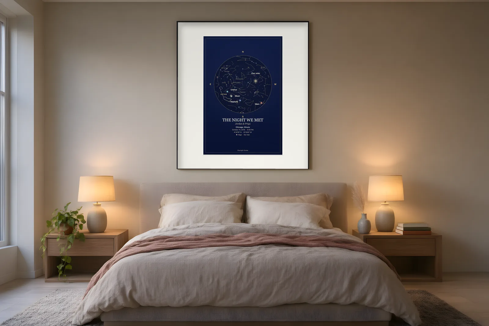 A navy star map titled 'The Night We Met' framed above a made bed with two glowing bedside lamps.